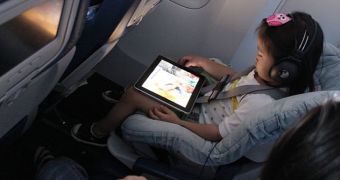 Child using an iPad on a plane