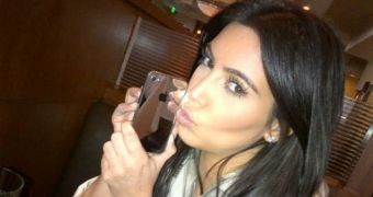 Kim Kardashian mirrored in her iPhone