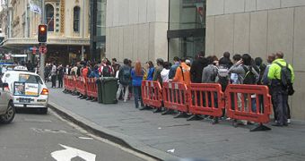 Apple fans sitting in line to buy the new iPhone 4S