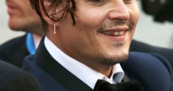 Johnny Depp at TIFF 2015, showing off a red tooth insert, in addition to metal and golden caps