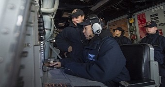 Operations Specialist 2nd Class Nanci Reyes and Boatswain’s Mate Seaman Velena Taylor monitor outbound merchant traffic aboard the Arleigh Burke-class guided-missile destroyer USS Cole (DDG 67) as they enter Constanta, Romania for a scheduled port visit
