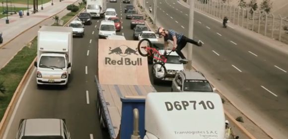 BMX Champion Performs Tricks on Moving Truck Half-Pipe – Video