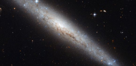 Hubble Zooms In on Dusty Spiral Galaxy