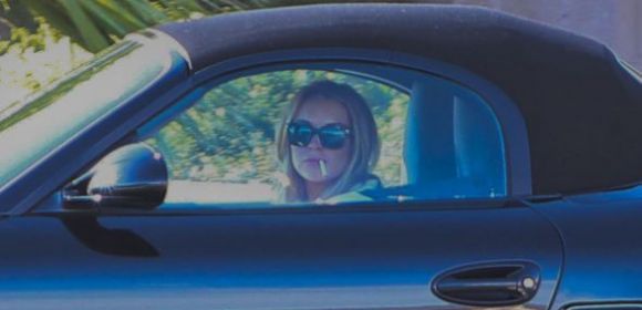 Lindsay Lohan Rolls in Style in Porsche – And Smoking