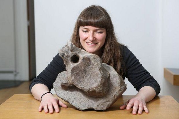 Sarah King, curator of Natural Science at the Yorkshire Museum in York, pictured together with the 176-million-year-old sauropod vertebra