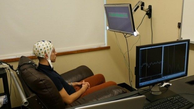University of Washington graduate student Jose Ceballos wears an electroencephalography (EEG) cap that records brain activity