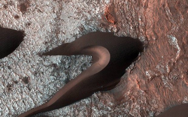 Sand dune and fractured terrain on Mars
