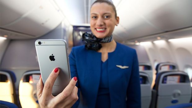 United Airlines flight attendant holding iPhone 6 Plus