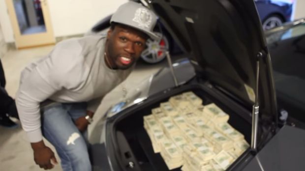 50 Cent filling a car's trunk with money