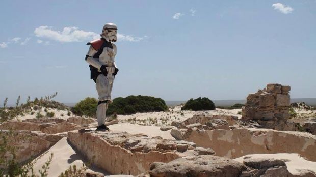A man is walking across Australia wearing a Stormtrooper costume