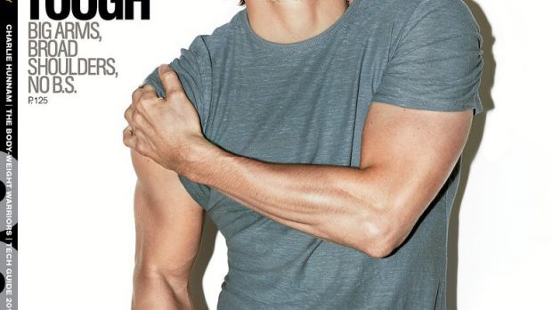 Charlie Hunnam shows off his muscles and megawatt smile on the December 2014 cover of Men’s Health
