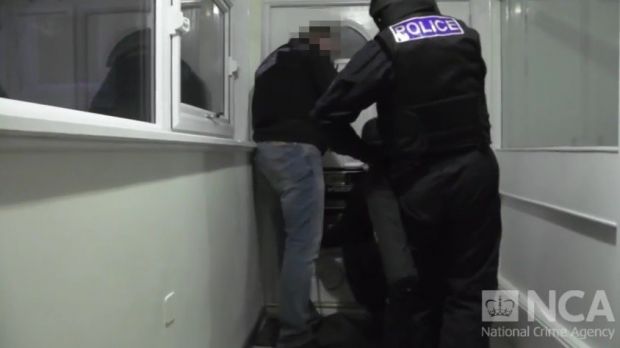 UK law enforcement raiding the home of one suspect