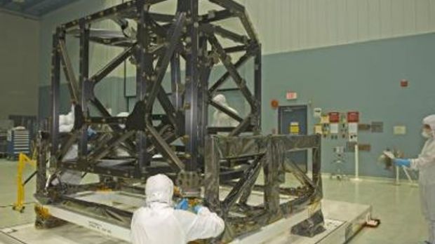 NASA engineers check out the unwrapped ISIM structure in a clean room. The ISIM Structure supports and holds four Webb telescope science instruments