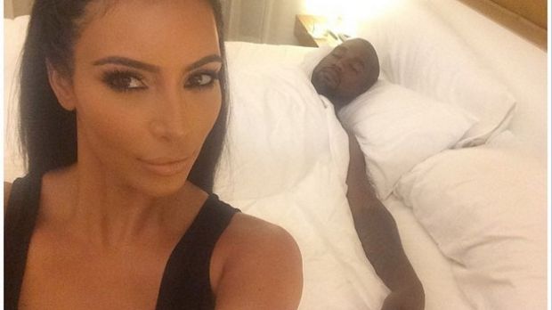 Kim Kardashian poses for selfie with a sleeping Kanye West