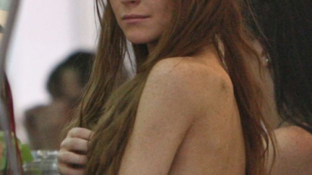 Lindsay Lohan shopping for reading glasses reveals skeletal frame in backless maxi dress