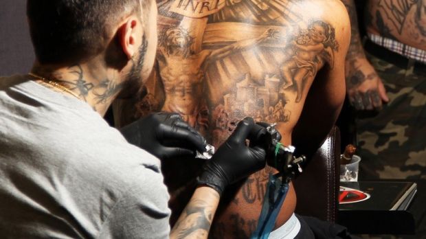 Nick Cannon shows off new, religious-themed back tattoo