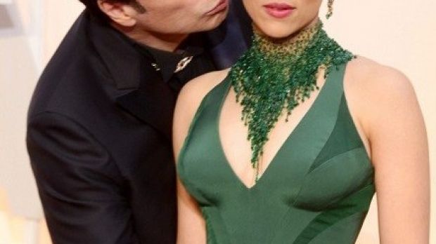 John Travolta creeps up on Scarlett Johansson on the red carpet at the Oscars 2015
