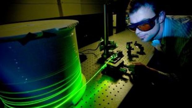 A researcher is testing an optical fiber system in the Institute for Photonics & Advanced Sensing, University of Adelaide
