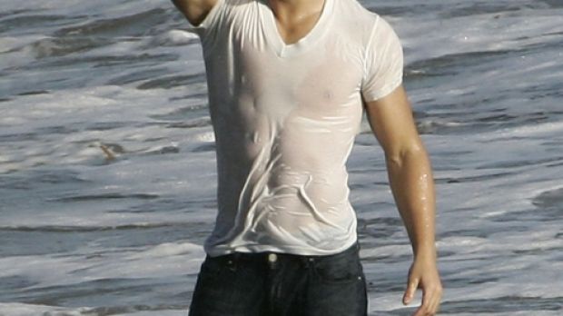Taylor Lautner during a photoshoot for Rolling Stone on a beach in LA
