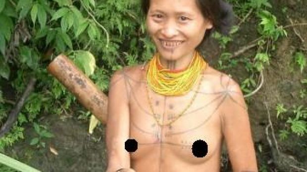 Siberut woman fishing. Notice the cut teeth and the tattoos
