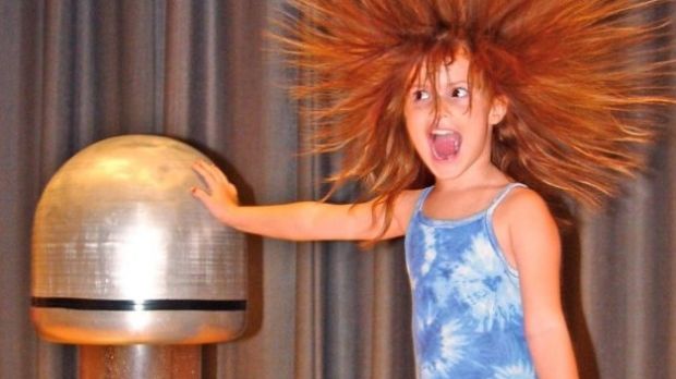 The 'hair raising' experience produced by the Van de Graaff generator, as electric charge is passed into a human body