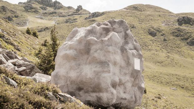 The boulder in this image is actually a cabin