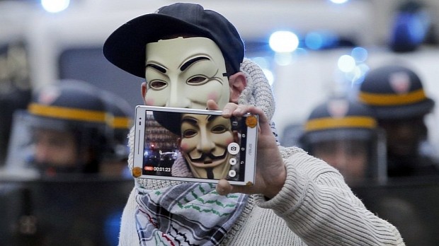 Protester wearing Guy Fawkes mask at UN Climate Change Summit protests in Paris, November 29