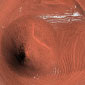 Collision Crater Uncovered by Erosion on Mars