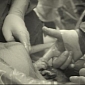 Infant in Womb Shown Holding Doctor's Hand During C-Section – Photo