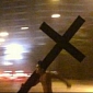 Man Takes Off His Clothes, Carries a Giant Cross Through Beijing