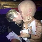 Photo of the Day: Miley Cyrus Makes Out with Man in Baby Mask