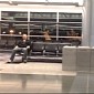 Watch: Man Stuck in Airport Shoots Cheesy Fun Music Video with iPhone and Tape