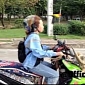 Woman Rides Skull Scooter While Parrot Flies Beside Her – Video