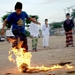 Young Boys Play Soccer with Flaming Coconuts in Indonesia