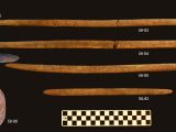 Stone projectile points and associated decorated antler foreshafts found in the burial pit