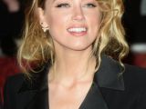 Happier than ever: Amber Heard beams on the red carpet in London