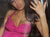 Amy Winehouse rocking a pink swimsuit and what looks like a baby bump