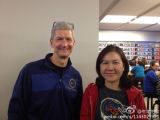 Tim Cook visiting Apple store in China, having his photo taken with a fan