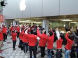 Apple staffers cheer along with the customers as the "Lucky Bag" celebration starts at another retail store