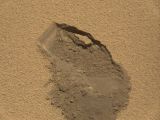 The mark left by Curiosity scooping up sand from the Martian surface