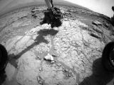 The drill descending onto the Martian rock