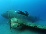 Divers explore a sunken aircraft which was used in WWII