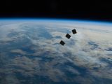 The three CubeSats floating away