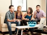Griffin PartyDock promo material featuring four friends enjoying a game on a big TV screen using the included controllers