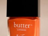 Choose a matching orange nail polish for your papaya lipstick