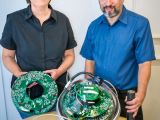 Berkeley Lab researchers Lisa Gerhardt and Spencer Klein with one of IceCube's 5,160 Digital Optical Modules (DOM)