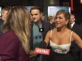 Jennifer Aniston greets the Extra reporter with a peck on the cheek and a side-hug