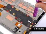Removing screws securing the motherboard on the Lenovo Yoga 2 Tablet