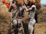 Maasai Warriors wearing hats made from the mane of a lion that they have each killed