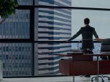 Christian Grey admires the view from his office in the Grey Towers, like a boss